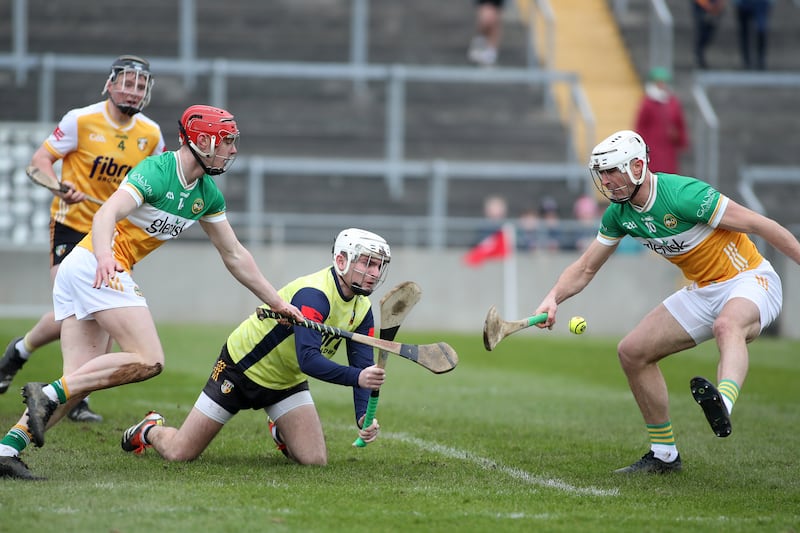 Antrim goalkeeper Ryan Elliott goes for a loose ball against Offaly's Charlie Mitchel and Oisin Kelly