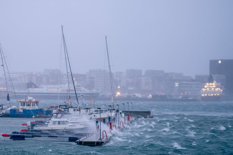 Boats in the harbour of Bodo, northern Norway, are battered by waves (Per-Inge Johnsen/NTB Scanpix via AP)