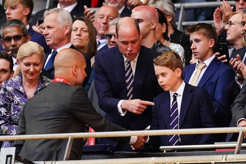 The Prince of Wales and Prince George speak with Manchester City manager Pep Guardiola following the Emirates FA Cup final at Wembley