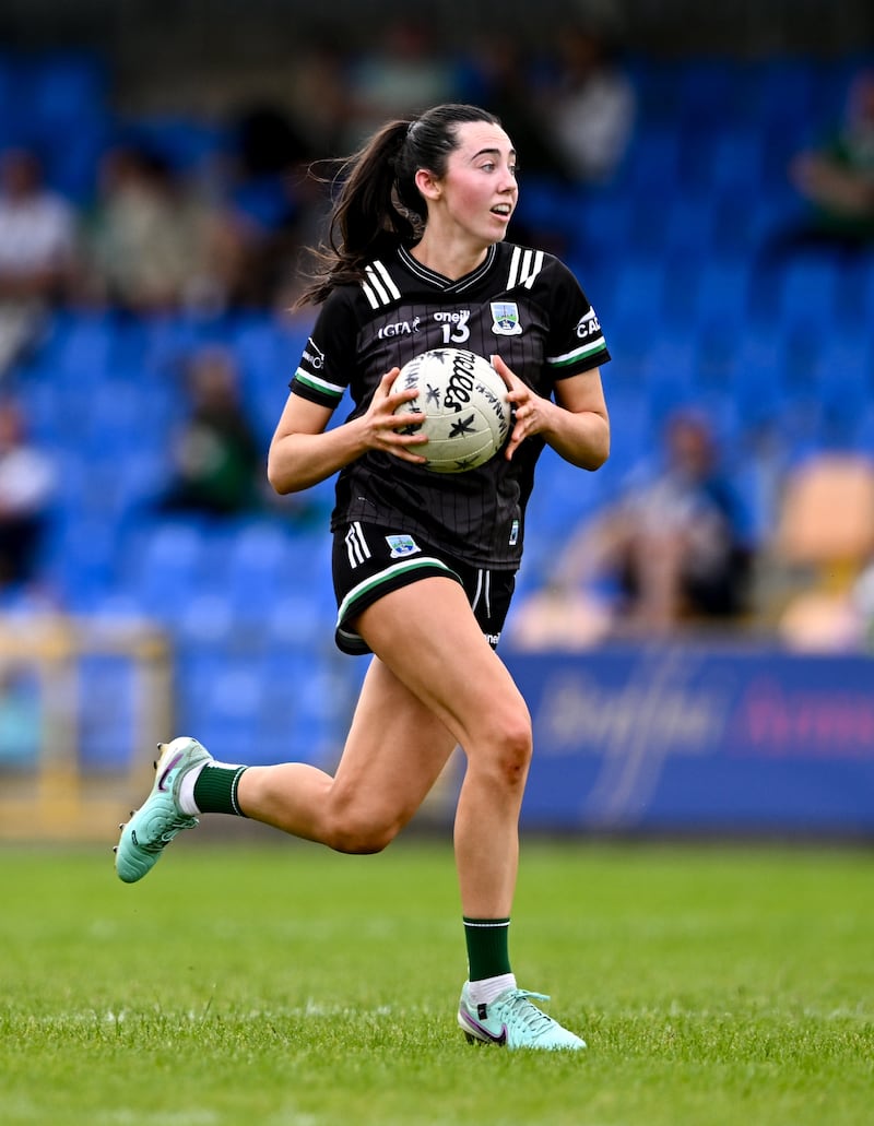 Blaithin Bogue carrying a ball during a match wearing a Fermanagh away kit