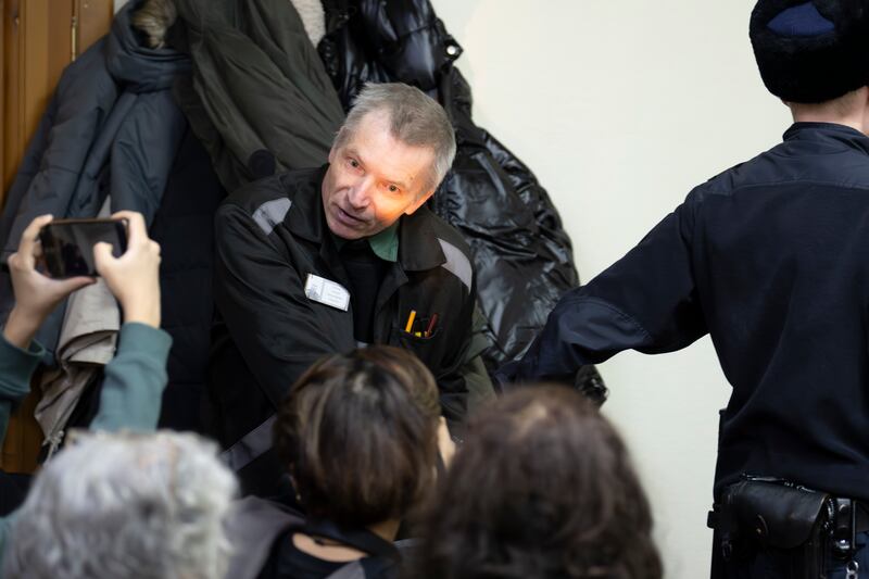 Imprisoned Kremlin critic Alexei Gorinov is escorted to court (Dmitry Serebryakov/AP)