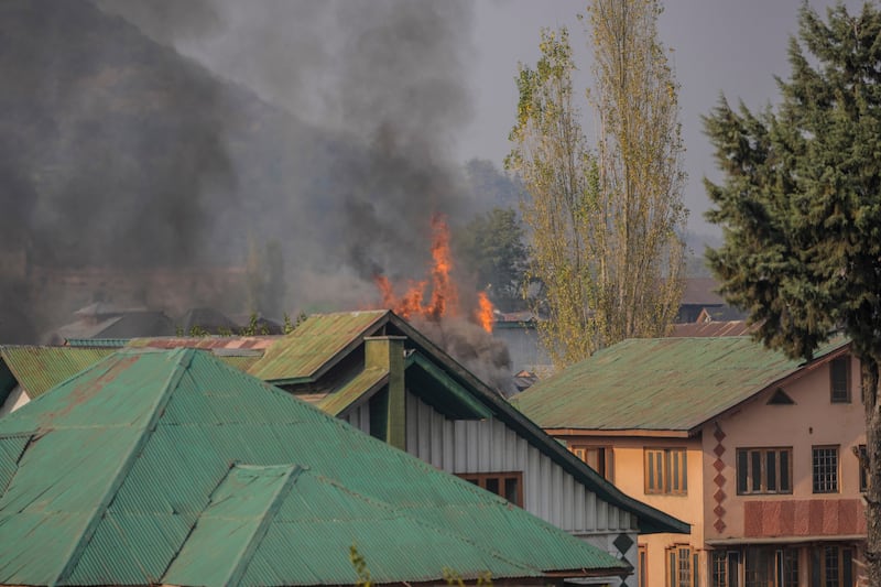 Flames billow from a residential building where militants are suspected to have taken refuge during a gun battle in Srinagar