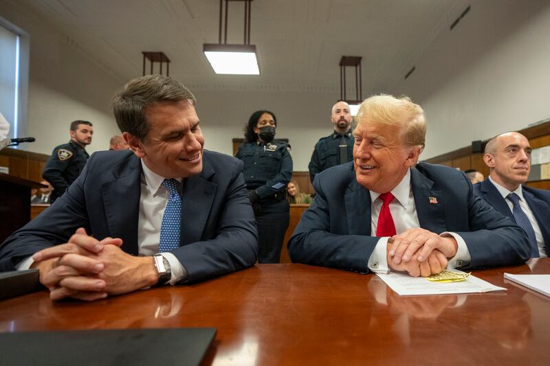 Former US president Donald Trump shares a light moment with his lawyer Todd Blanche while he attends his trial at Manhattan Criminal Court in New York (Steven Hirsch/New York Post via AP, Pool)