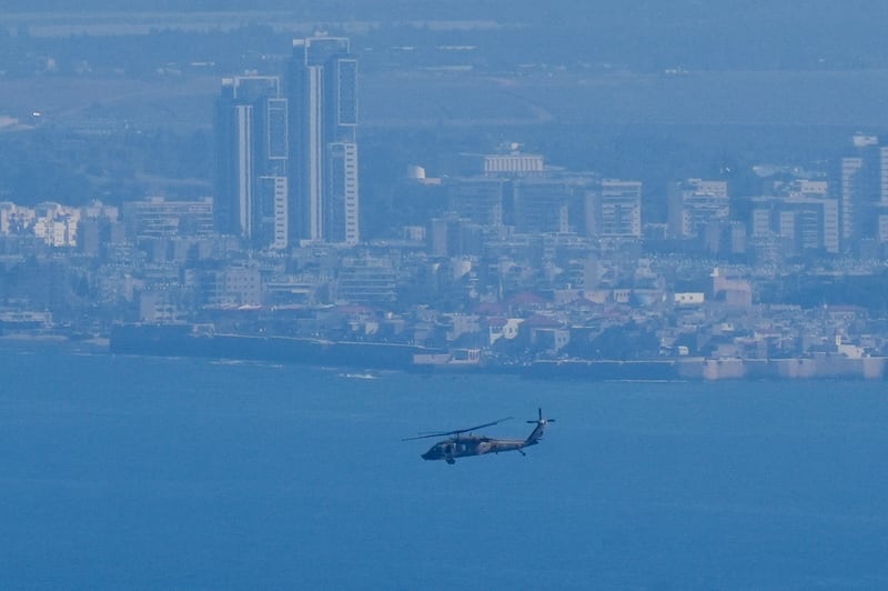 An Israeli Air Force Black Hawk helicopter flies over the Mediterranean Sea near the northern Israeli city of Kiryat Yam (Baz Ratner/AP)