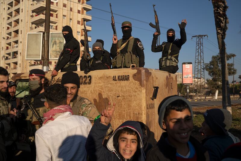 Members of the security forces of the newly formed Syrian government (Leo Correa/AP)