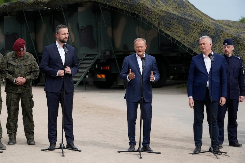 Poland’s Prime Minister Donald Tusk, Defence Minister Wladyslaw Kosiniak-Kamysz and Interior Minister Tomasz Siemoniak (Czarek Sokolowski/AP)