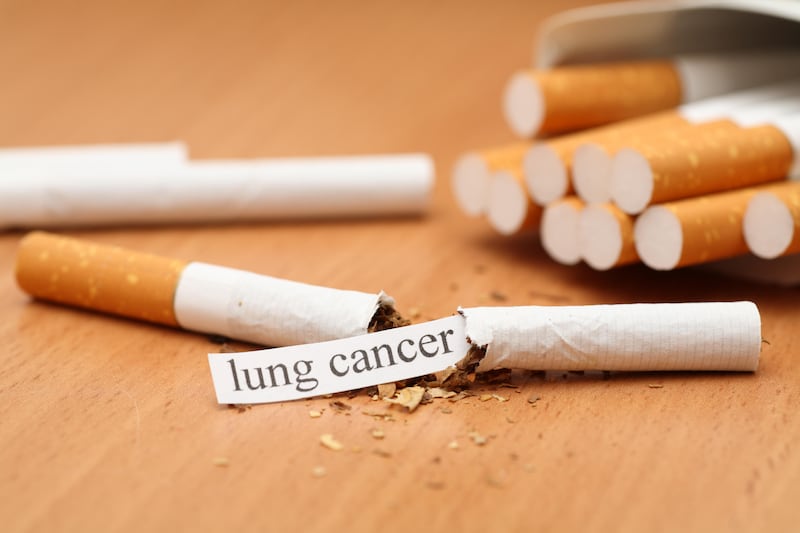 Broken cigarette with lung cancer message