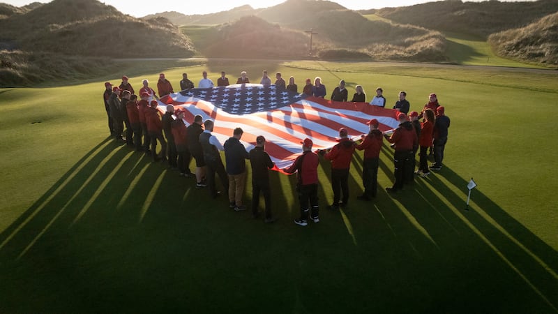 Trump International Scotland staff hold American flag in celebration of Donald Trump’s election victory