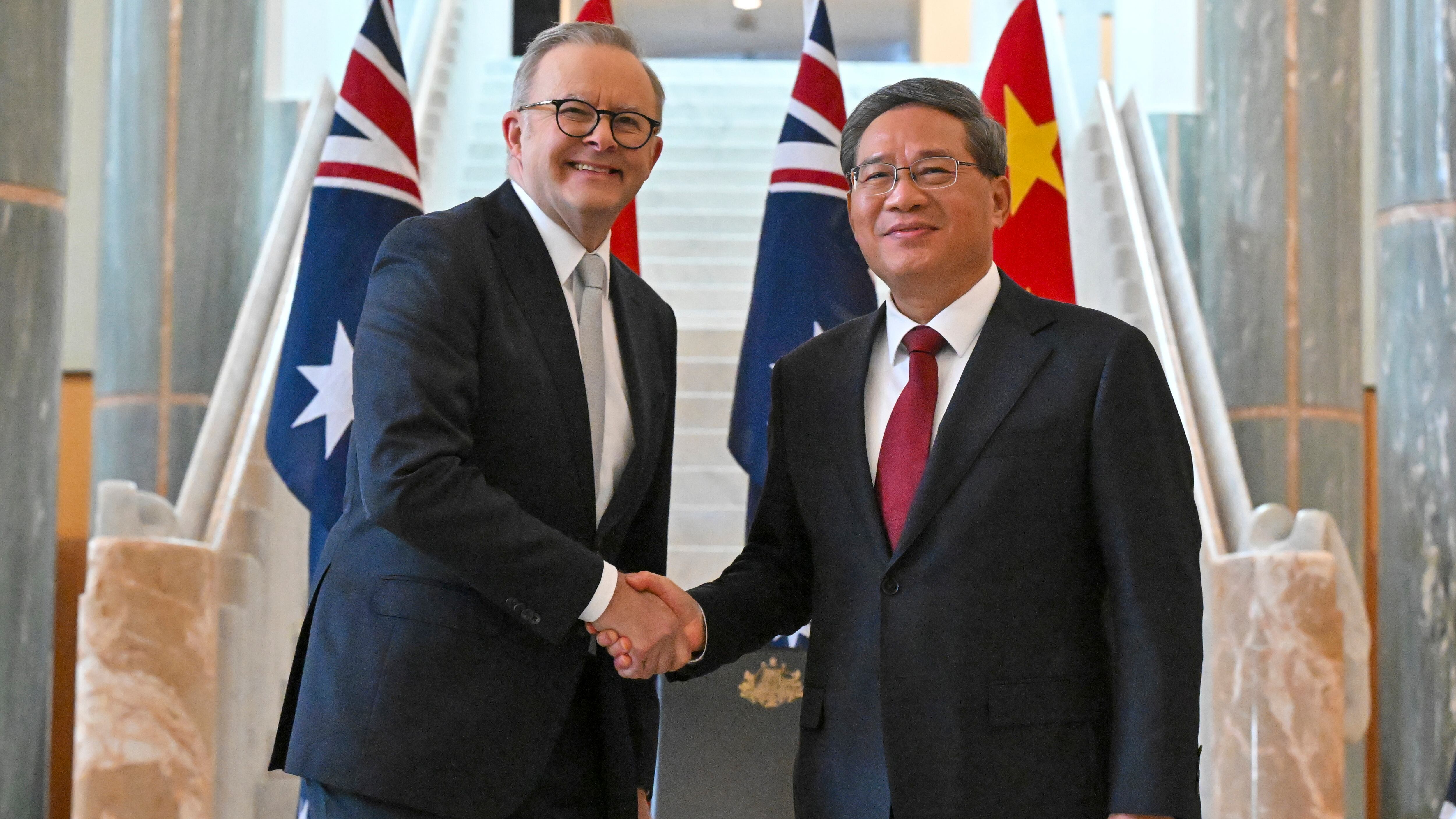 Chinese Premier Li Qiang and Australia’s Prime Minister Anthony Albanese shake hands at Parliament House in Canberra, Australia (Mick Tsikas/AP)