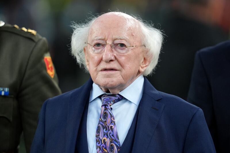 President of Ireland Michael D Higgins lit a candle to remember those who are missing