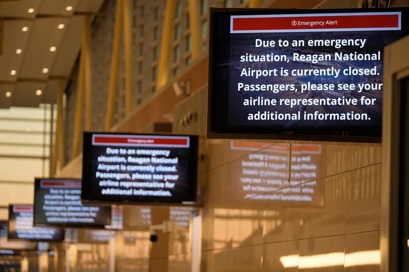 Signs display an emergency alert at Ronald Reagan Washington National Airport (Mark Schiefelbein/AP)