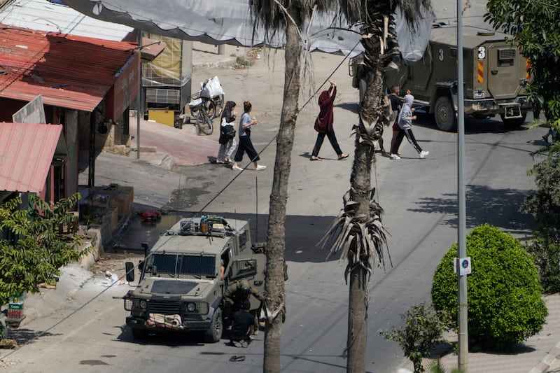 Israeli soldiers arrest a Palestinian man in Jenin, West Bank, on Thursday (Majdi Mohammed/AP)