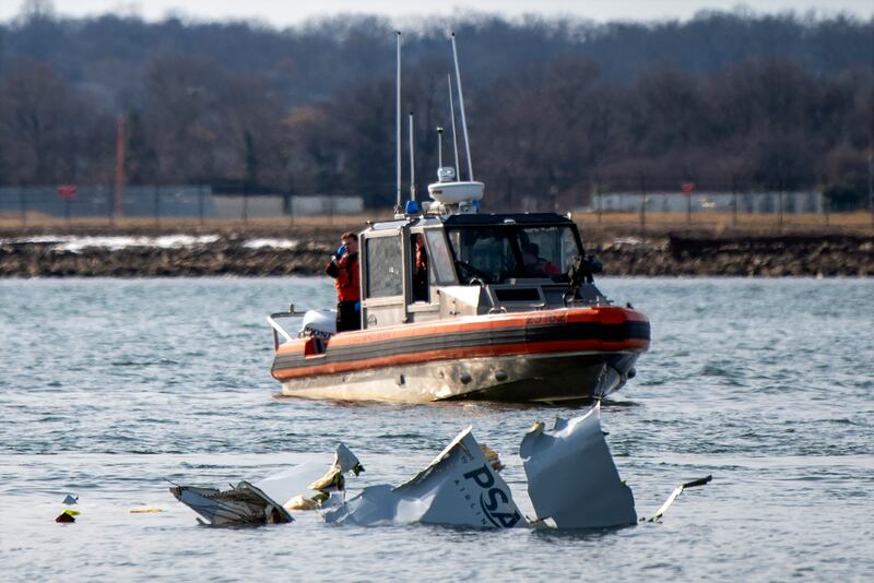 Boats work at the scene in the Potomac River near Ronald Reagan Washington National Airport (Petty Officer 2nd Class Taylor Bacon/AP)