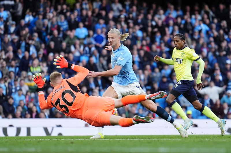 Southampton goalkeeper Aaron Ramsdale (left) saves at the feet of Manchester City’s Erling Haaland