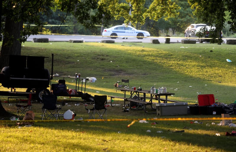 Debris is strewn about as police tape seals off an area of Maplewood Park, Rochester, New York (Tina MacIntyre-Yee/AP)