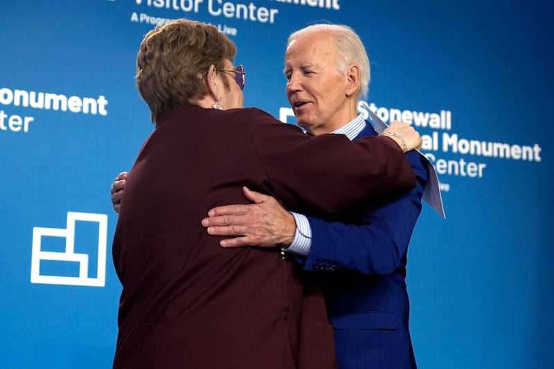 President Joe Biden hugs Sir Elton John at the grand opening ceremony for the Stonewall National Monument Visitor Centre in New York (Evan Vucci/AP)
