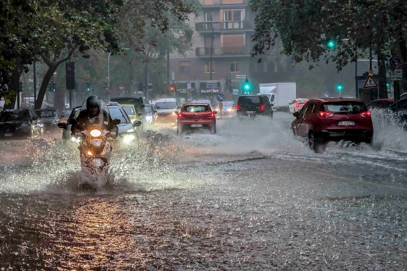 Drivers in flooded streets in Milan (Claudio Furlan/LaPresse/AP)