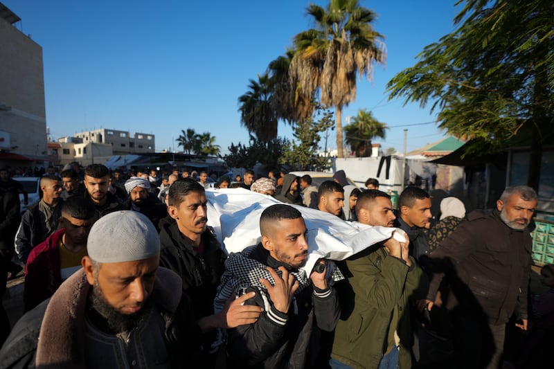 Palestinians carry the body of victim of an overnight Israeli strike, during a funeral in Deir al-Balah, Gaza Strip, on Wednesday (Abdel Kareem Hana/AP)