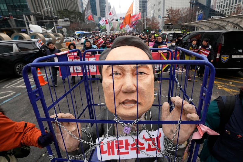 Protesters carry a caricature of impeached South Korean President Yoon Suk Yeol during a rally demanding his arrest in Seoul, South Korea (AP Photo/Ahn Young-joon)