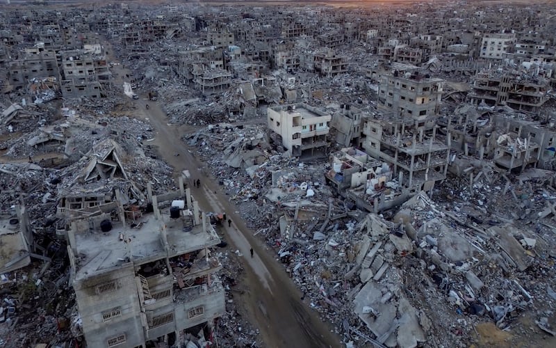 An aerial photograph taken by a drone shows Palestinians walking through the destruction caused by the Israeli air and ground offensive, in Rafah, Gaza Strip (Jehad Alshrafi/AP)