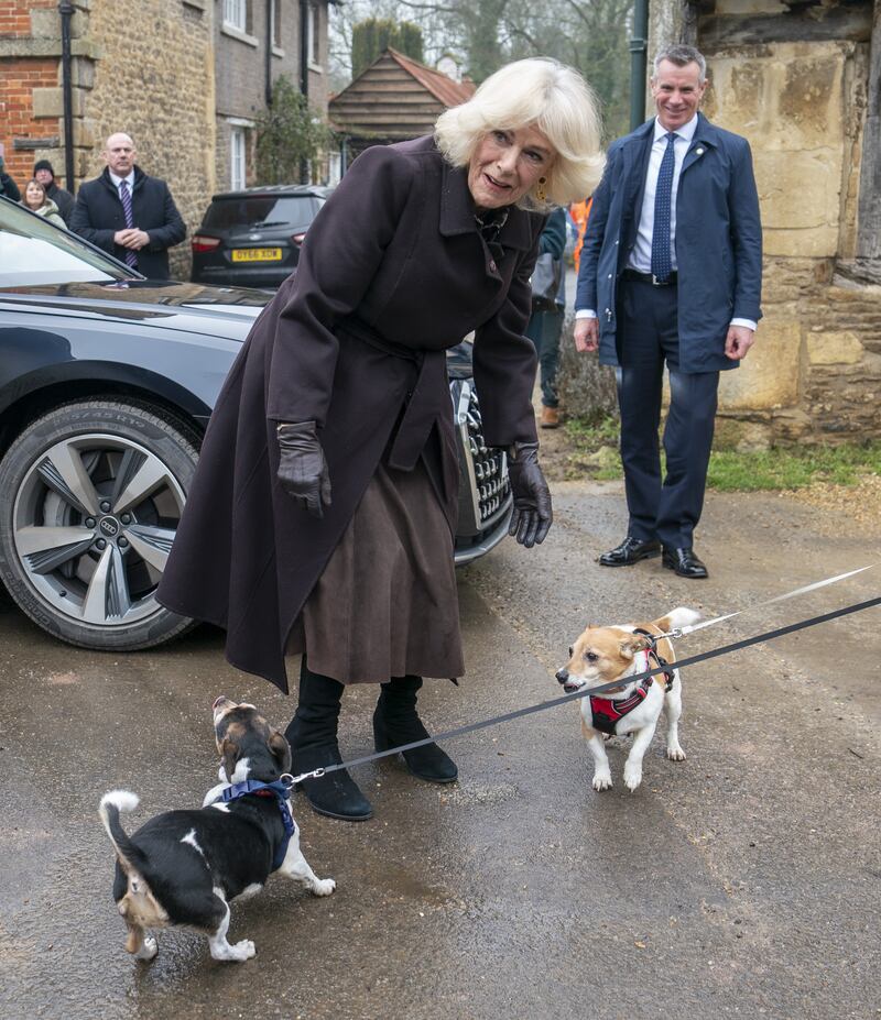 The Queen greeting Beth and Bluebell, who she adopted from Battersea Dogs and Cats Home