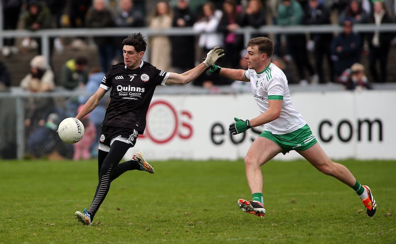 Kilcoo's Eugene Branagan in action with   Burren's Ryan Magill in yesterdays  Senior Football Final at Pairc Esler