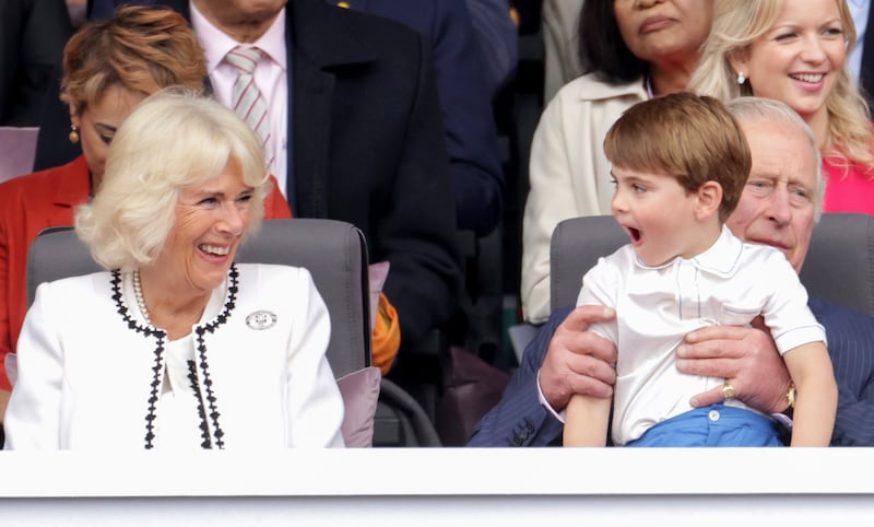 Then then-Duchess of Cornwall laughs with Prince Louis, who sits on his grandfather’s lap, during the Platinum Jubilee celebrations