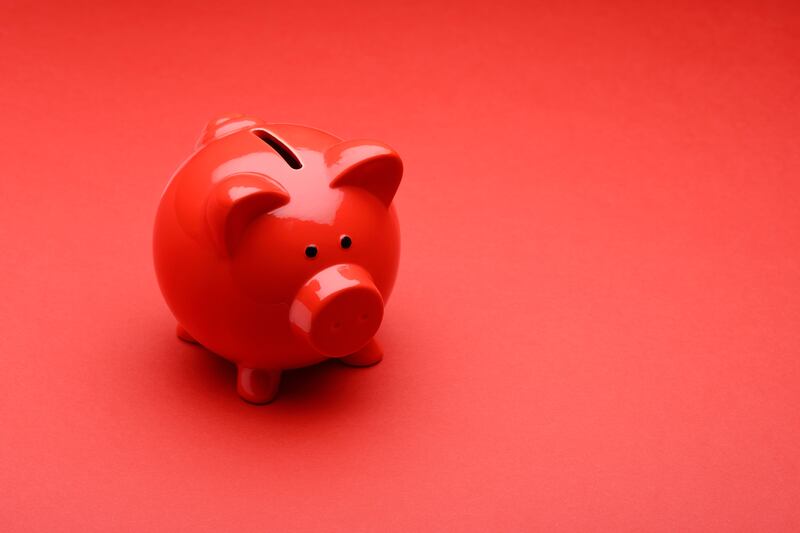 Red piggy bank on a red background