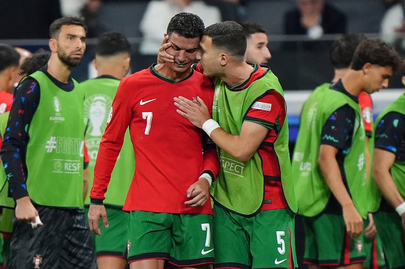 Cristiano Ronaldo is consoled by Diogo Dalot at half-time of extra-time after being denied from the penalty spot