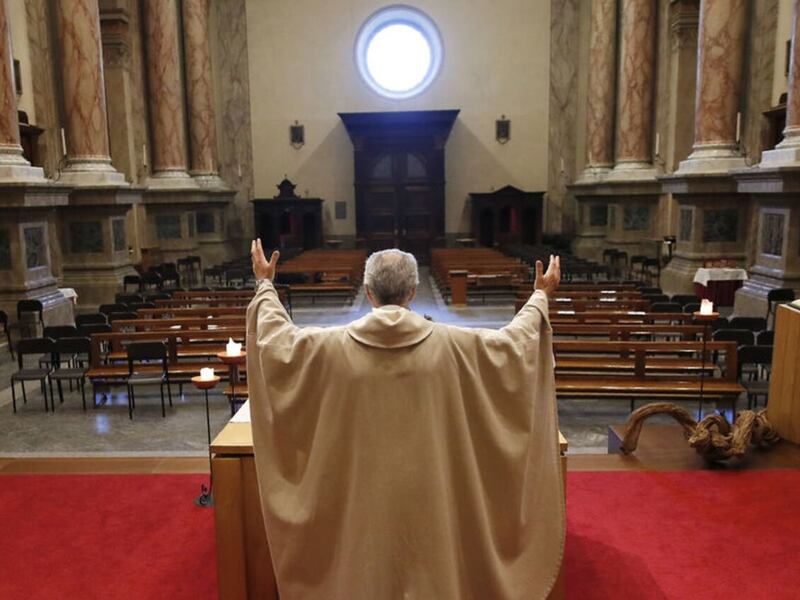 Queen’s University Belfast is  seeking answers on how the pandemic affected the role of religion.  Pictured in April 2020, Fr Angelow Riva celebrates mass in an empty church in Carenno, Italy. PICTURE: AP/ANTONIO CALANNI