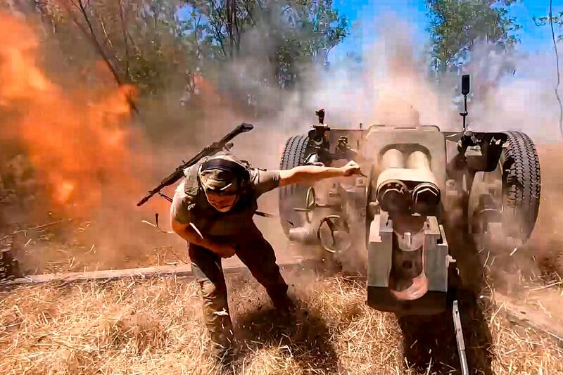 A Russian soldier fires from D-30 howitzer towards Ukrainian positions in an undisclosed location in Ukraine (Russian Defence Ministry/AP)