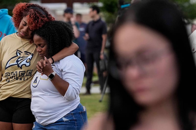 Mourners pray during a candlelight vigil for students and teachers killed at Apalachee High School in Georgia (Mike Stewart/AP)