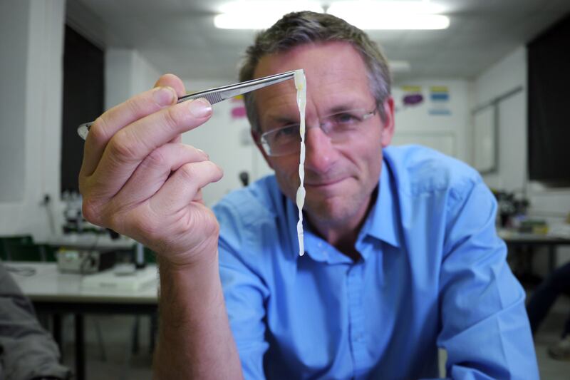 Michael Mosley holding up a piece of human tapeworm as Mosley lived with tapeworms in his guts for six weeks for a documentary (Nathan Williams/BBC)