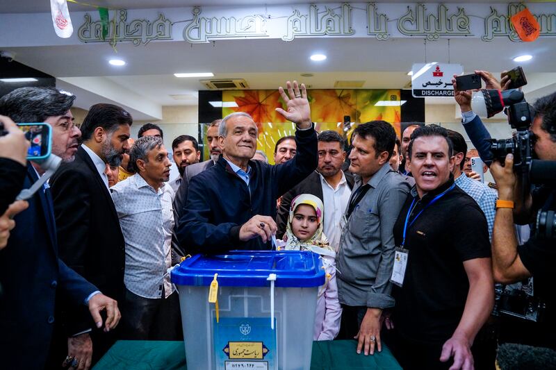 Reformist candidate for the Iranian presidential election Masoud Pezeshkian casts his ballot (Amir Kholousi, ISNA via AP)