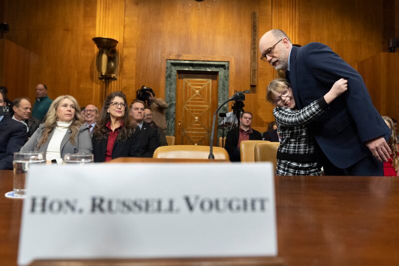 Russell Vought is hugged by his daughter Porter as he arrives to appear at a Senate Budget Committee hearing examining his nomination (AP/Jacquelyn Martin)