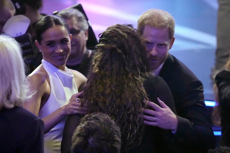 Prince Harry, right, and his wife Meghan Markle, are greeted as they arrive at the ESPY Awards on Thursday (Mark J Terrill/AP)