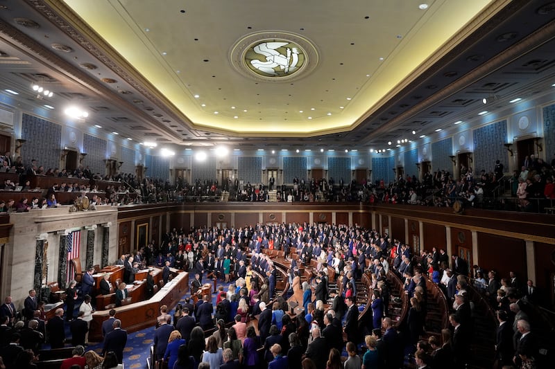 Members bow their heads during the opening prayer as the House of Representatives meets to elect a speaker and convene the new 119th Congress at the Capitol in Washington (Mark Schiefelbein/AP)