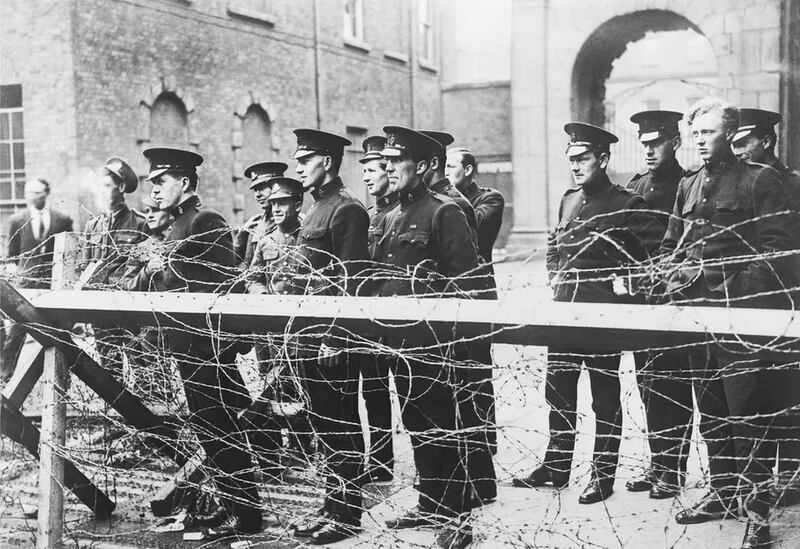 Members of the Royal Irish Constabulary standing behind barbed wire