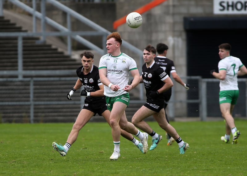 Burren's Danny Magill in action against  Kilcoo's Shealan Johnston and Callum Rogers during Sunday's Down SFC final at Páirc Esler         Picture: Seamus  Loughran