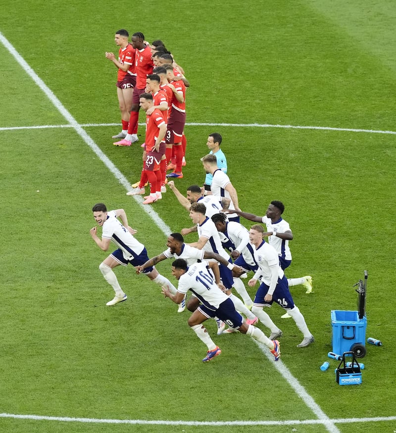 England players celebrate after Trent Alexander-Arnold scores the winning penalty against Switzerland