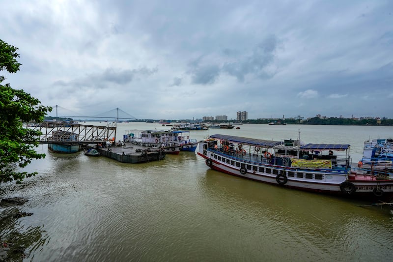 Boats were left moored on the Hooghly River and ferry services were suspended as Tropical Storm Dana approached land (Bikas Das/AP)