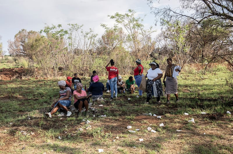 Relatives of miners and community members wait at a mine shaft where an estimated 4,000 illegal miners are trapped (AP)