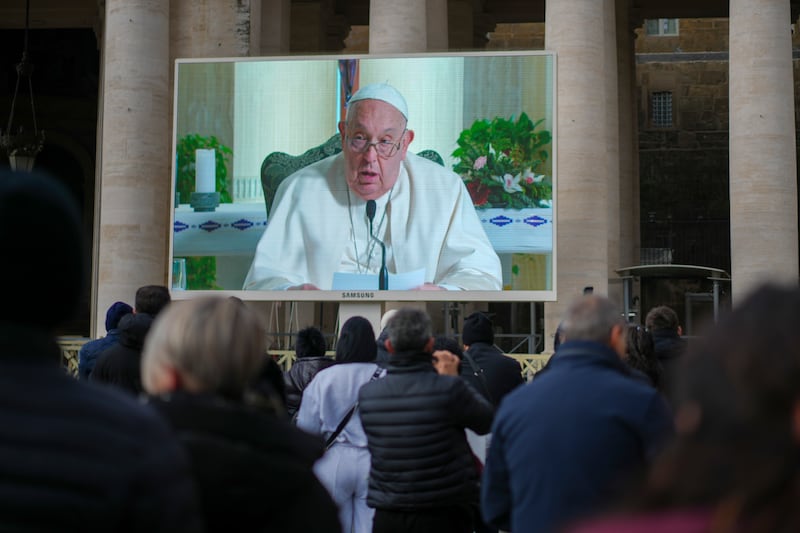 Those gathered in St Peter’s Square watched the Pope’s address on big screens (Andrew Medichini/AP)