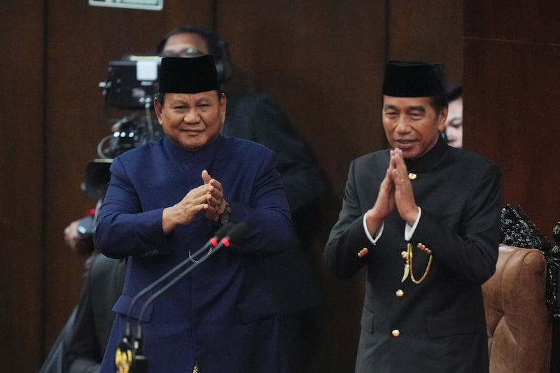 Indonesia’s new president, Prabowo Subianto, left, and former president, Joko Widodo, salute during the inauguration ceremony at the Parliament building in Jakarta (Tatan Syuflana/AP)