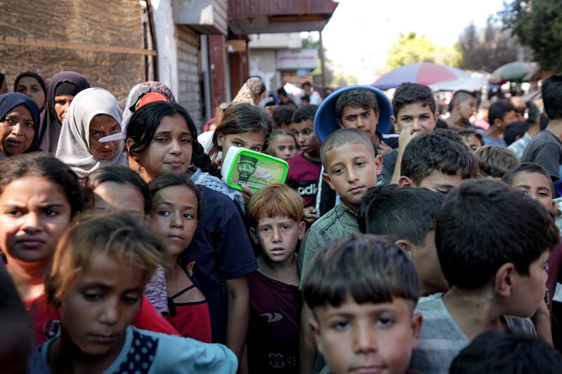 Palestinians queue up for food distribution in Deir al-Balah, Gaza Strip, in mid-October (Abdel Kareem Hana/AP)