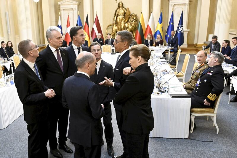 German Chancellor Olaf Scholz, front left, and Denmark’s Prime Minister Mette Frederiksen, front right, talk during a summit of the Baltic Sea Nato countries in Helsinki, Finland (Vesa Moilanen/Lehtikuva/AP)