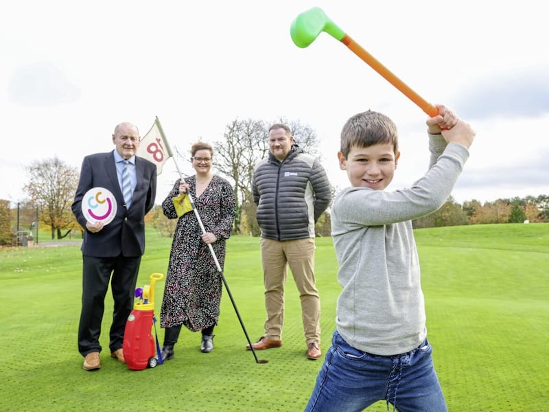 McQuillan Companies led the drive for &pound;130,000 with friends and colleagues from the business community following its biennial golf classic for the Children&rsquo;s Cancer Unity Charity. The event at Rockmount Golf Club, attended by over 250 golfers, was organised by a group of local businesspeople who make up the CCUC golf committee. This is the fifth event of its kind, which sees all funds go to the Children&rsquo;s Cancer Unit at the Royal Belfast Hospital for Sick Children, having raised well over half a million pound since its establishment in 2014. Conor Maguire (8) tees off watched by Johnny and John McQuillan from McQuillan Companies and Jane Hoare from the Children&#39;s Cancer Unit Charity. Picture: Darren Kidd/PressEye 