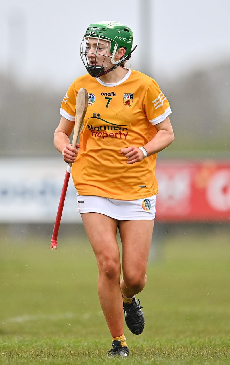 Antrim's Erin Coulter running in an Antrim Camogie kit and a green helmet