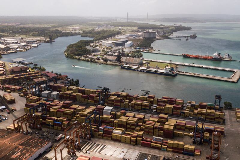 Cargo containers sit stacked as cranes load and unload containers from cargo ships at the Cristobal port, operated by the Panama Ports Company, in Colon, Panama (Matias Delacroix/AP)