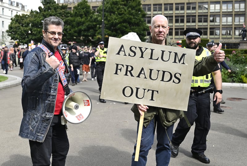 One man’s sign read ‘asylum frauds out’